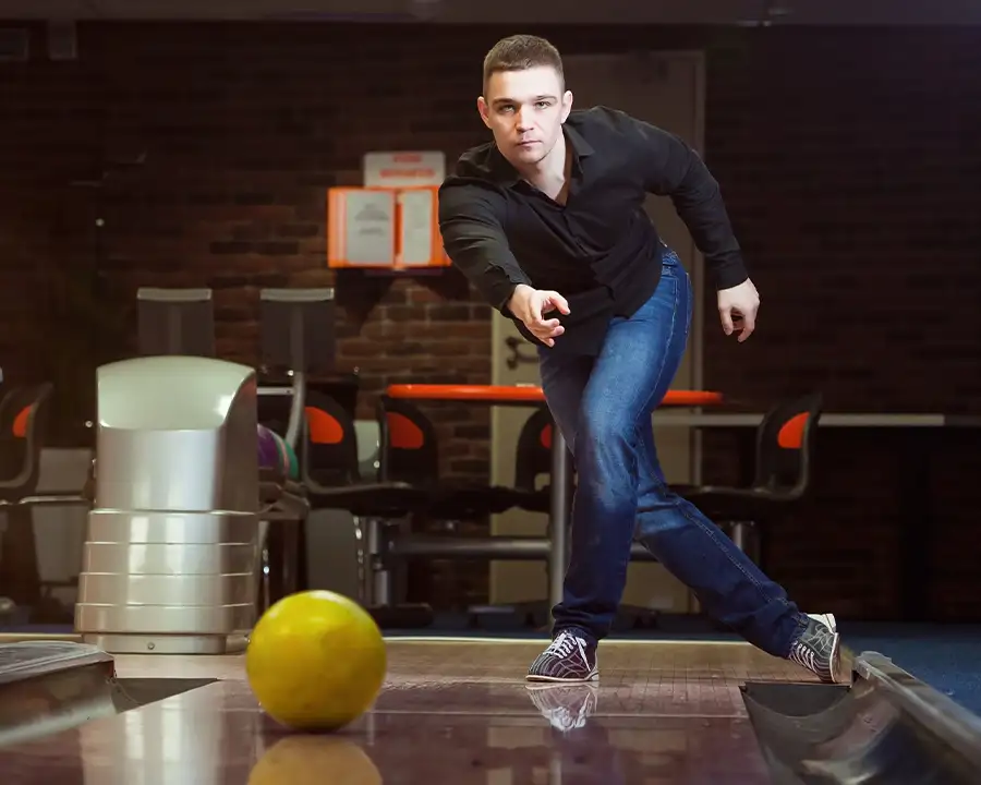 Man in a black shirt releasing a bowling ball down the lane at Championship Lanes in Anderson, IN - League/Tournament Bowling