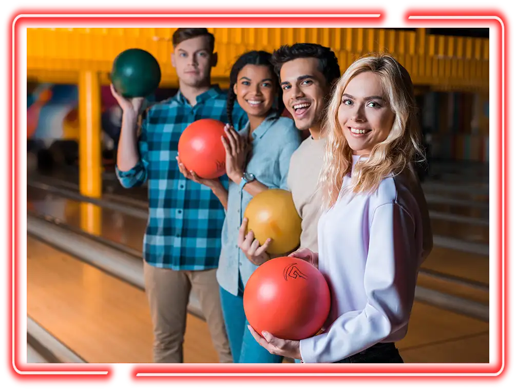 Group of friends holding bowling balls before a game at Championship Lanes in Anderson, IN
