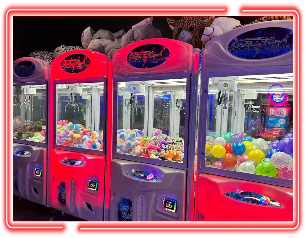 Claw machines filled with plush toys and bouncy balls at Championship Lanes Game Room in Anderson, IN