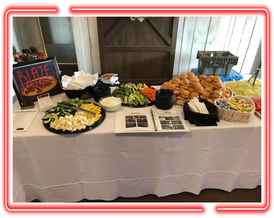 Catered appetizer spread with sliders and veggie trays provided by Events By Blaze, from Championship Lanes in Anderson, IN