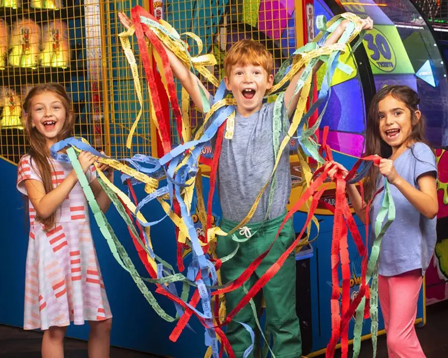 Kids celebrating with arcade prize tickets at Championship Lanes in Anderson, IN