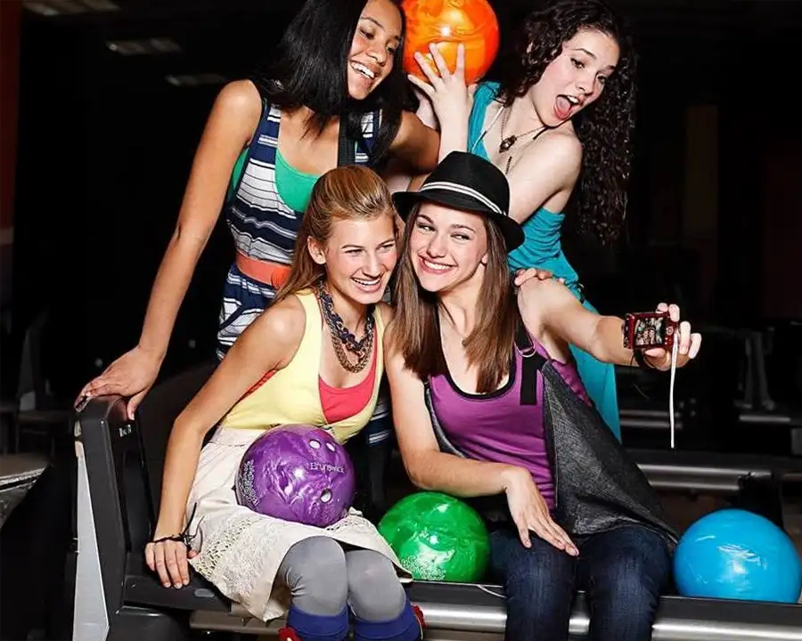 Teen Friends taking a selfie with bowling balls at Championship Lanes in Anderson, IN