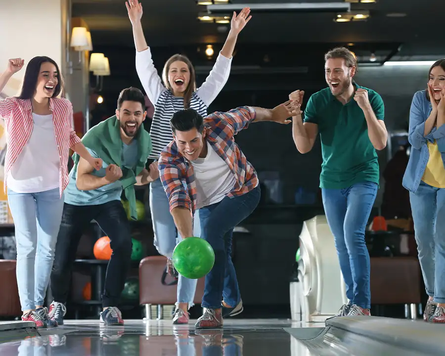 Adult Friends cheering during a bowling party at Championship Lanes in Anderson, IN